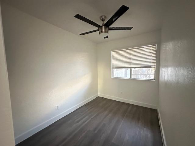 18202 North Cave Creek Road, Unit 209 Phoenix, AZ 85032 - Photo 9 of 12 an empty room with wooden floor ceiling fan and windows