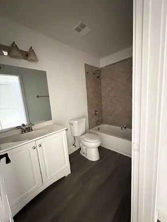 a bathroom with a toilet a sink and bathtub