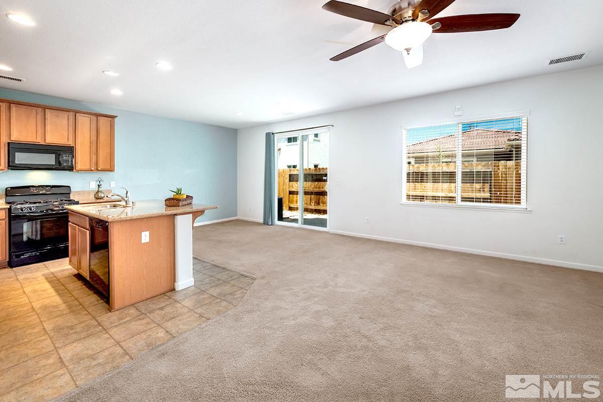 2025 Waterhouse Road Reno, NV 89521 - Photo 7 of 20 a view of a kitchen with a stove cabinets a ceiling fan and wooden floor