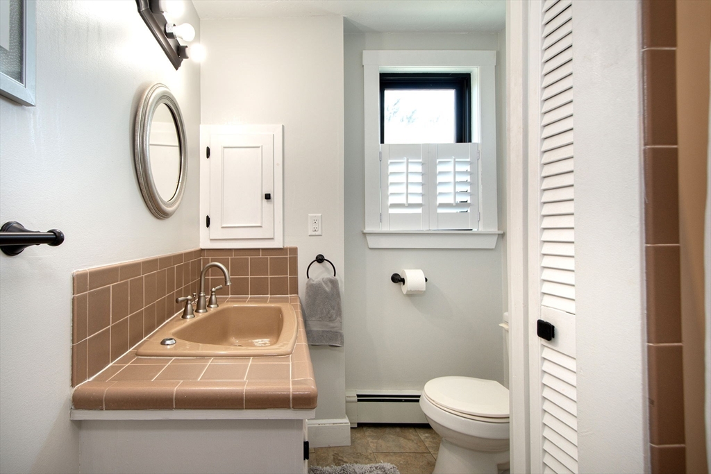 20 Driftway Scituate, MA 02066 - Photo 20 of 42 a bathroom with a sink a toilet and a mirror