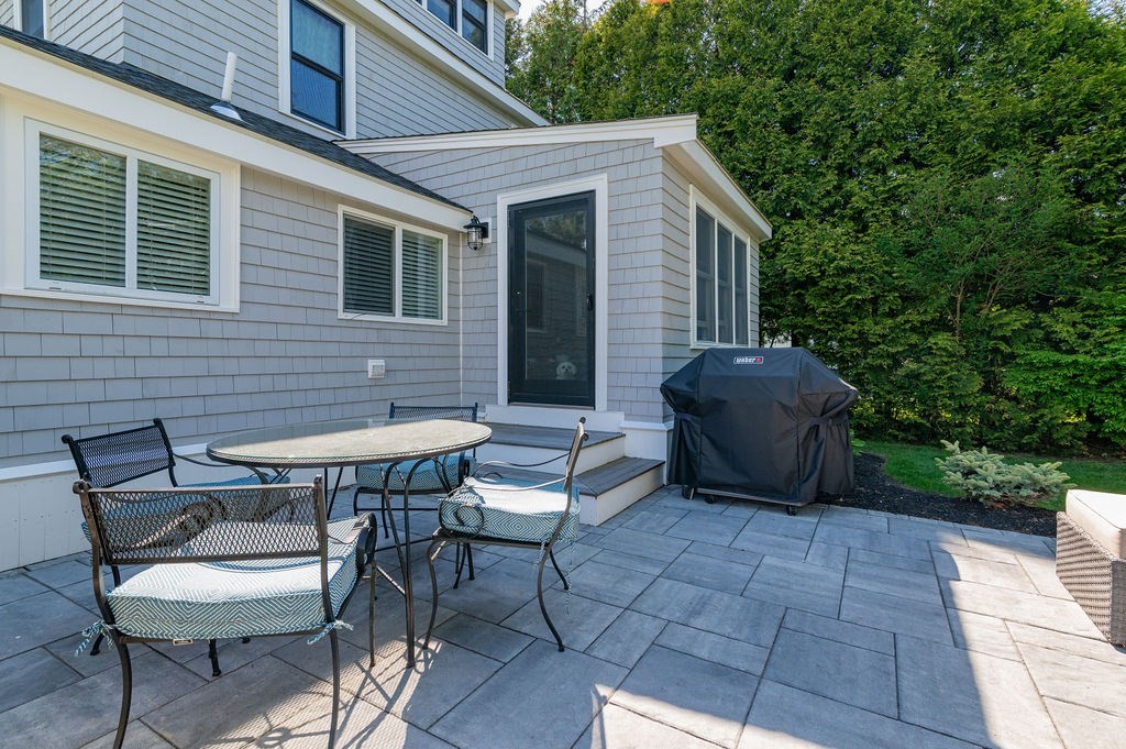 20 Driftway Scituate, MA 02066 - Photo 29 of 42 a backyard of a house with table and chairs