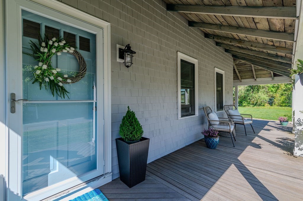 20 Driftway Scituate, MA 02066 - Photo 6 of 42 a view of a porch with chairs and potted plants