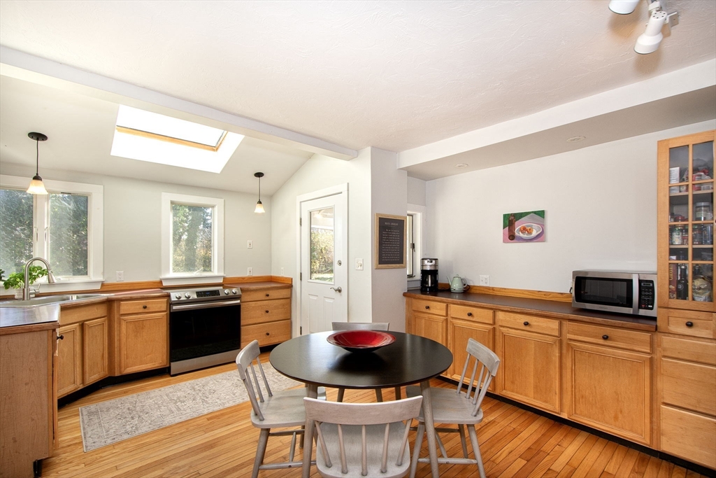 20 Driftway Scituate, MA 02066 - Photo 7 of 42 a kitchen with stainless steel appliances granite countertop a stove a sink dishwasher and a refrigerator with wooden floor