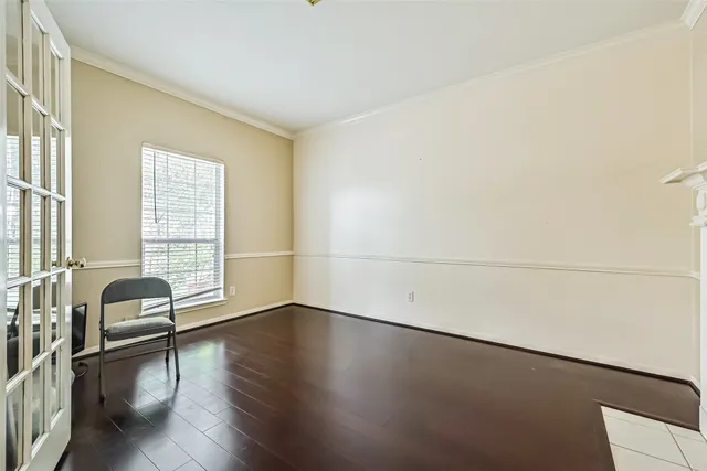 a view of a livingroom with wooden floor and furniture
