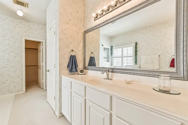 a bathroom with a double vanity sink and mirror