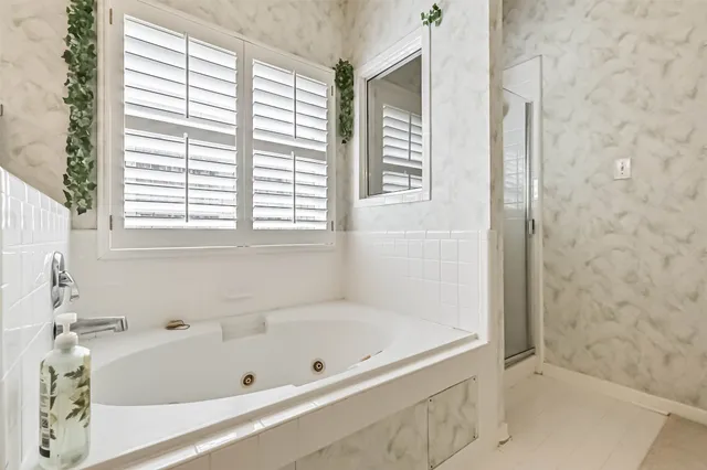 a bathroom with a bathtub and window