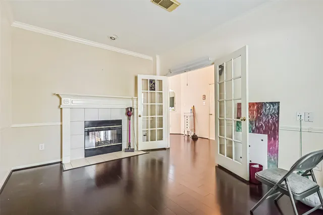 a view of a livingroom with wooden floor and a fireplace
