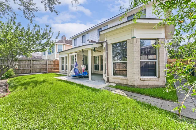 a view of a house with a yard and sitting area