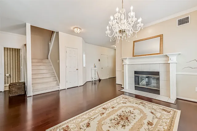 a view of a livingroom with wooden floor a fireplace and a window