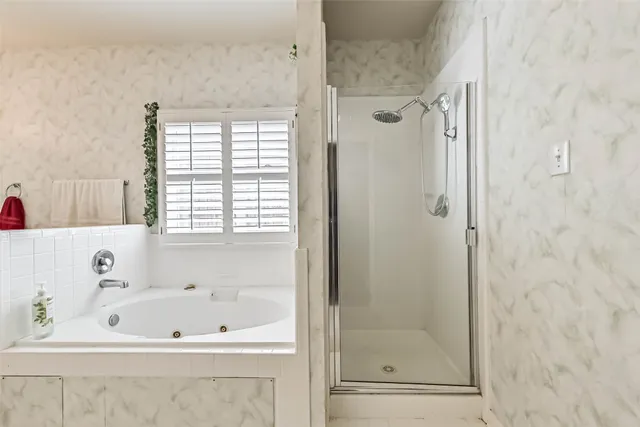a bathroom with a bathtub and a shower