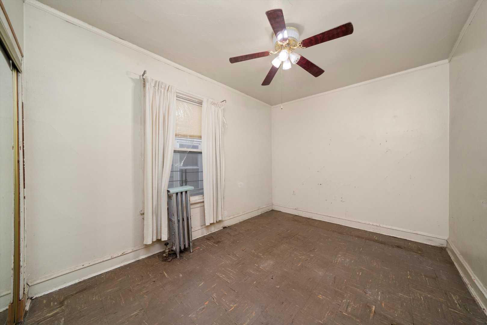 7611 South Aberdeen Street Chicago, IL 60620 - Photo 19 of 45 an empty room with closet and a ceiling fan