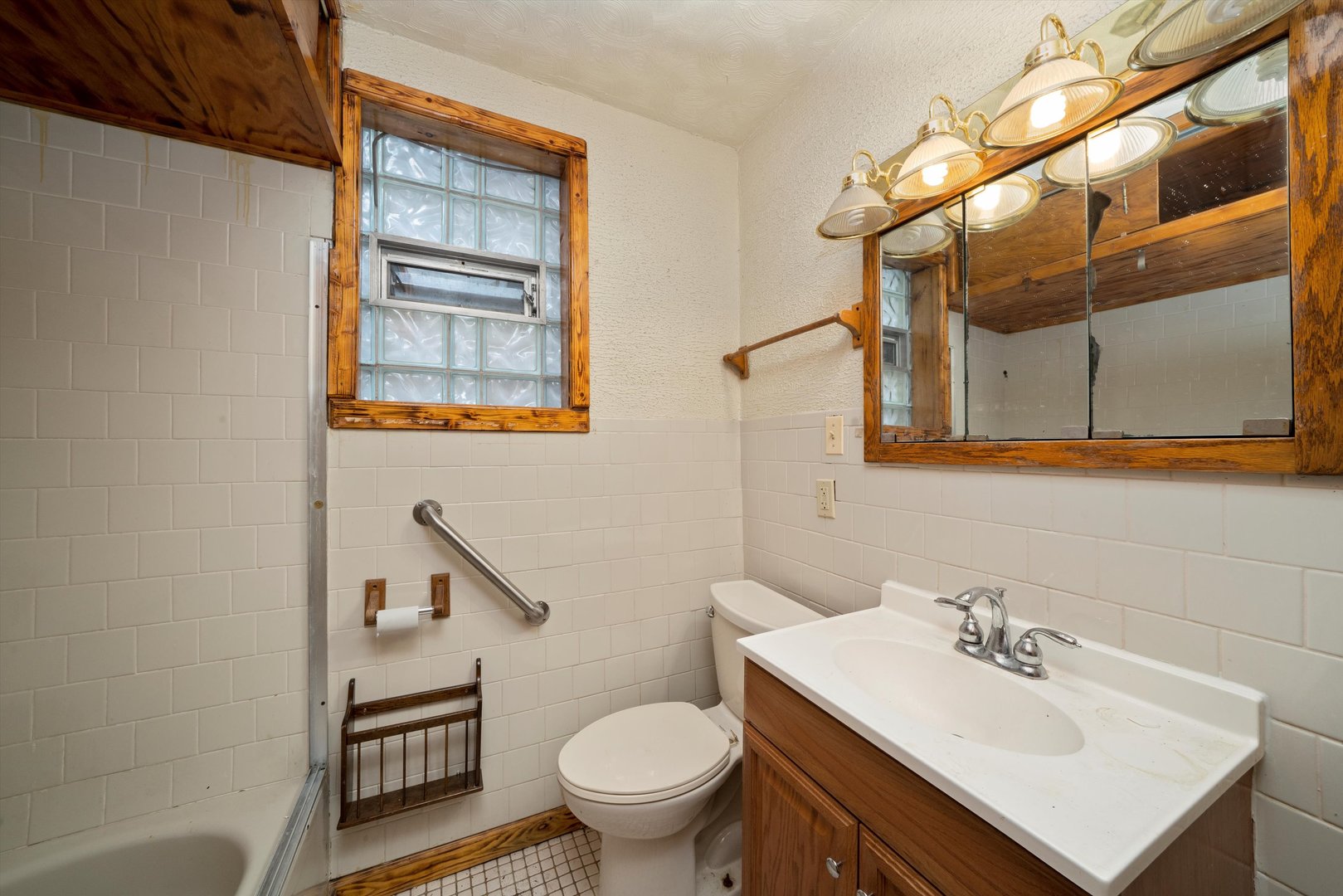 7611 South Aberdeen Street Chicago, IL 60620 - Photo 21 of 45 a bathroom with a sink toilet and a mirror