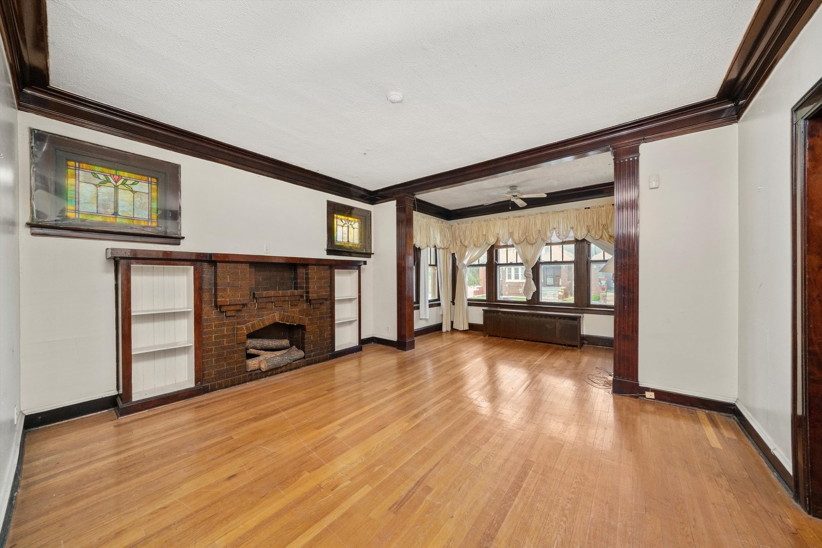 7611 South Aberdeen Street Chicago, IL 60620 - Photo 6 of 45 a view of a livingroom with wooden floor and a fireplace