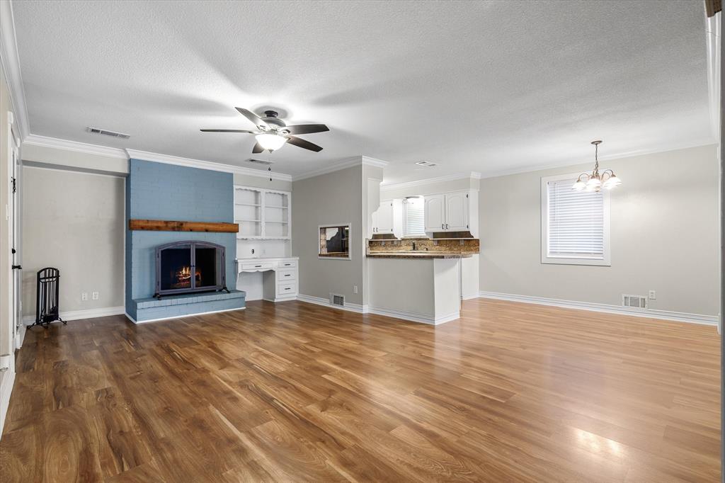 913 Pinson Road Forney, TX 75126 - Photo 4 of 19 Living space with wood burning fireplace.