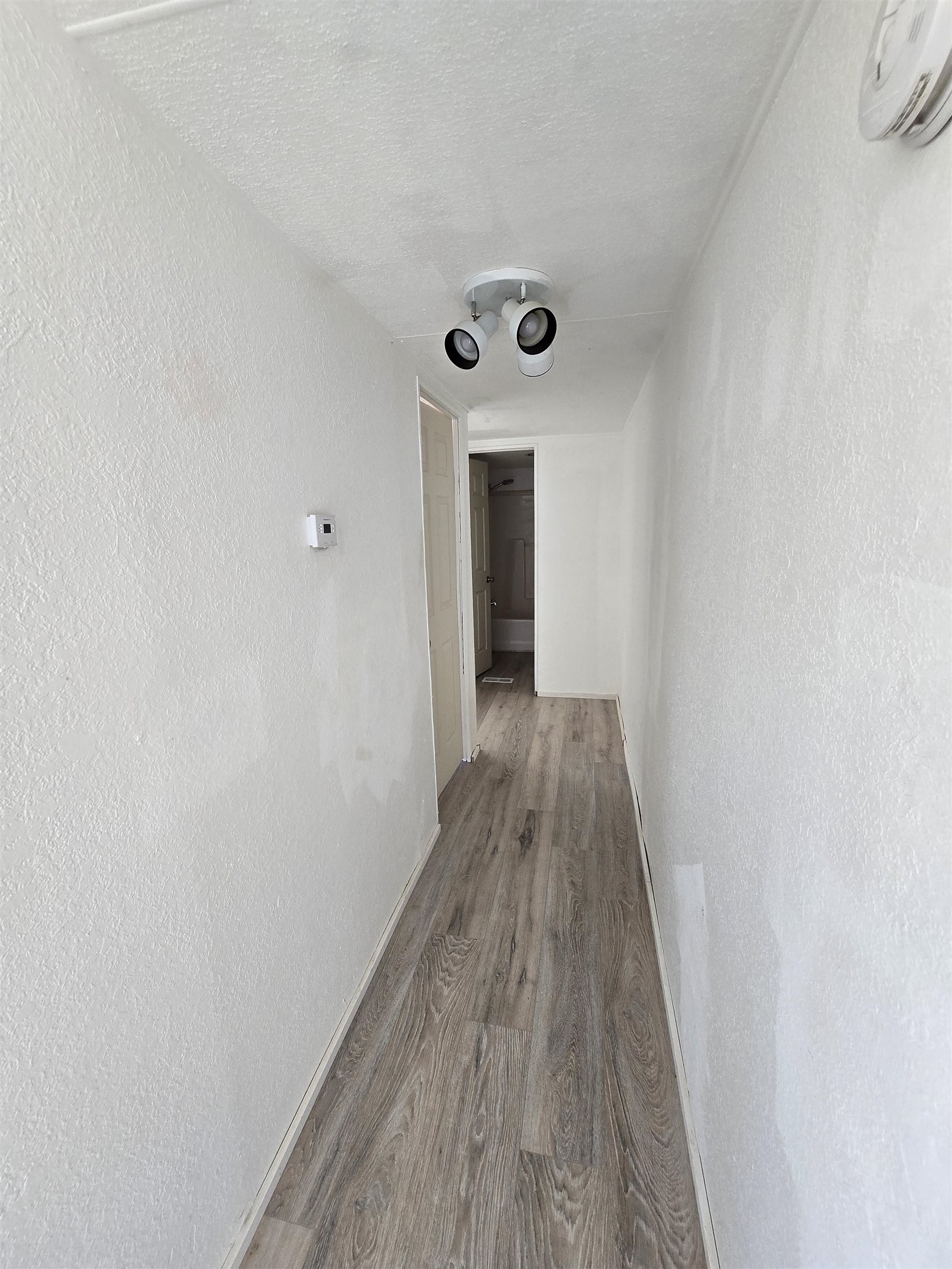 675 1/2 24 1/2 Road Grand Junction, CO 81505 - Photo 11 of 25 a view of a hallway with wooden floor