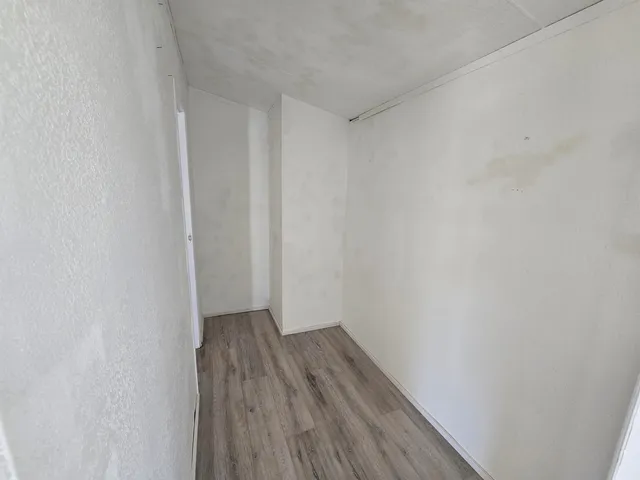 a view of a small space with wooden floor