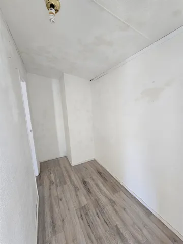 an empty room with wooden floor