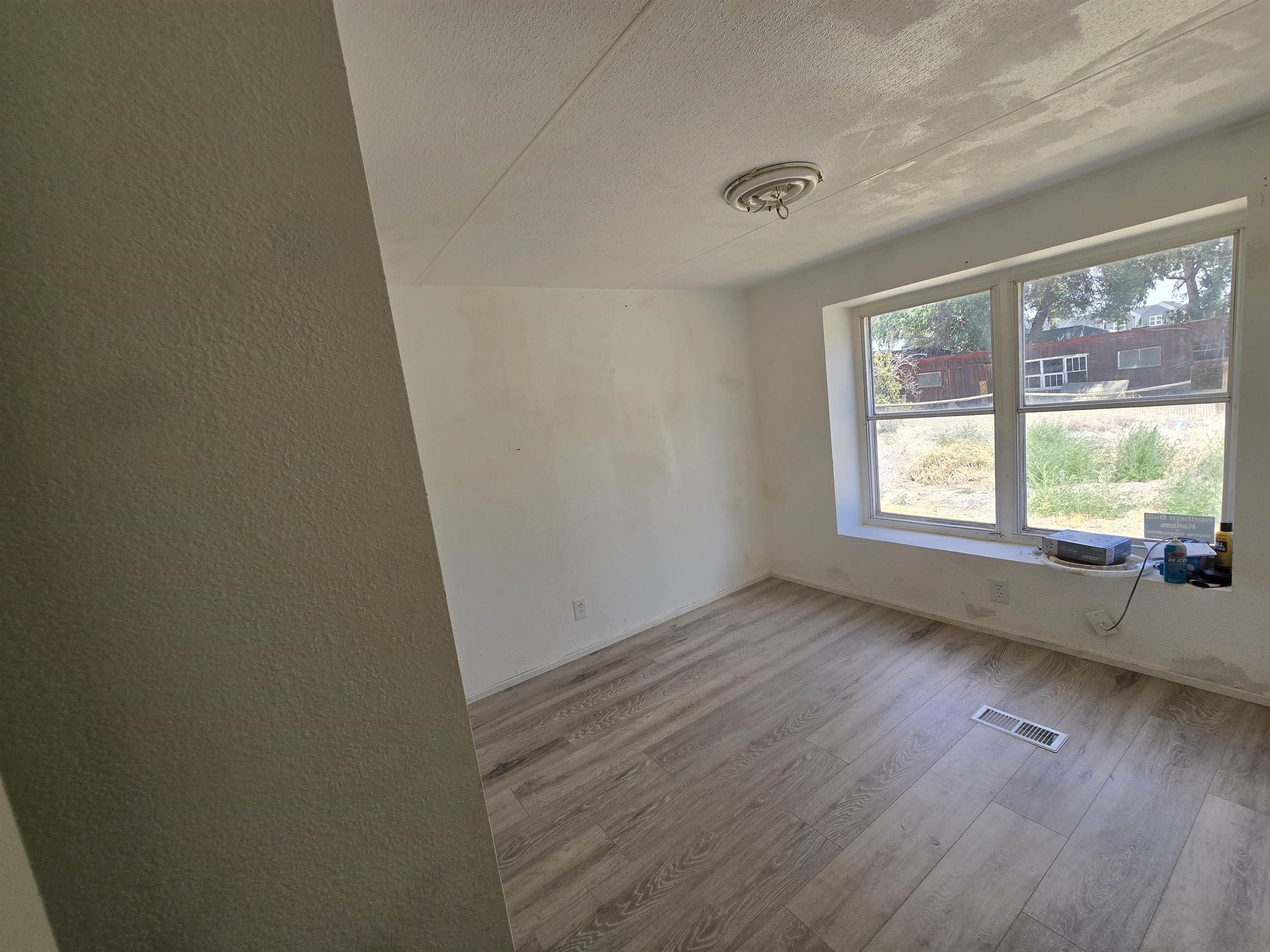 675 1/2 24 1/2 Road Grand Junction, CO 81505 - Photo 15 of 25 a view of an empty room with wooden floor and a window