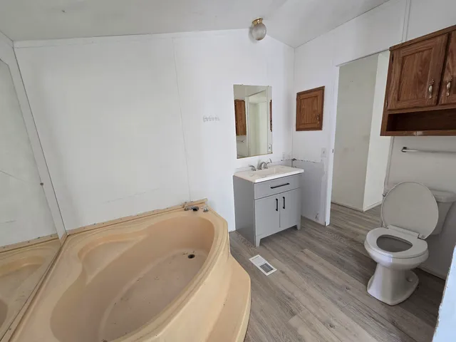 a bathroom with a toilet sink and mirror