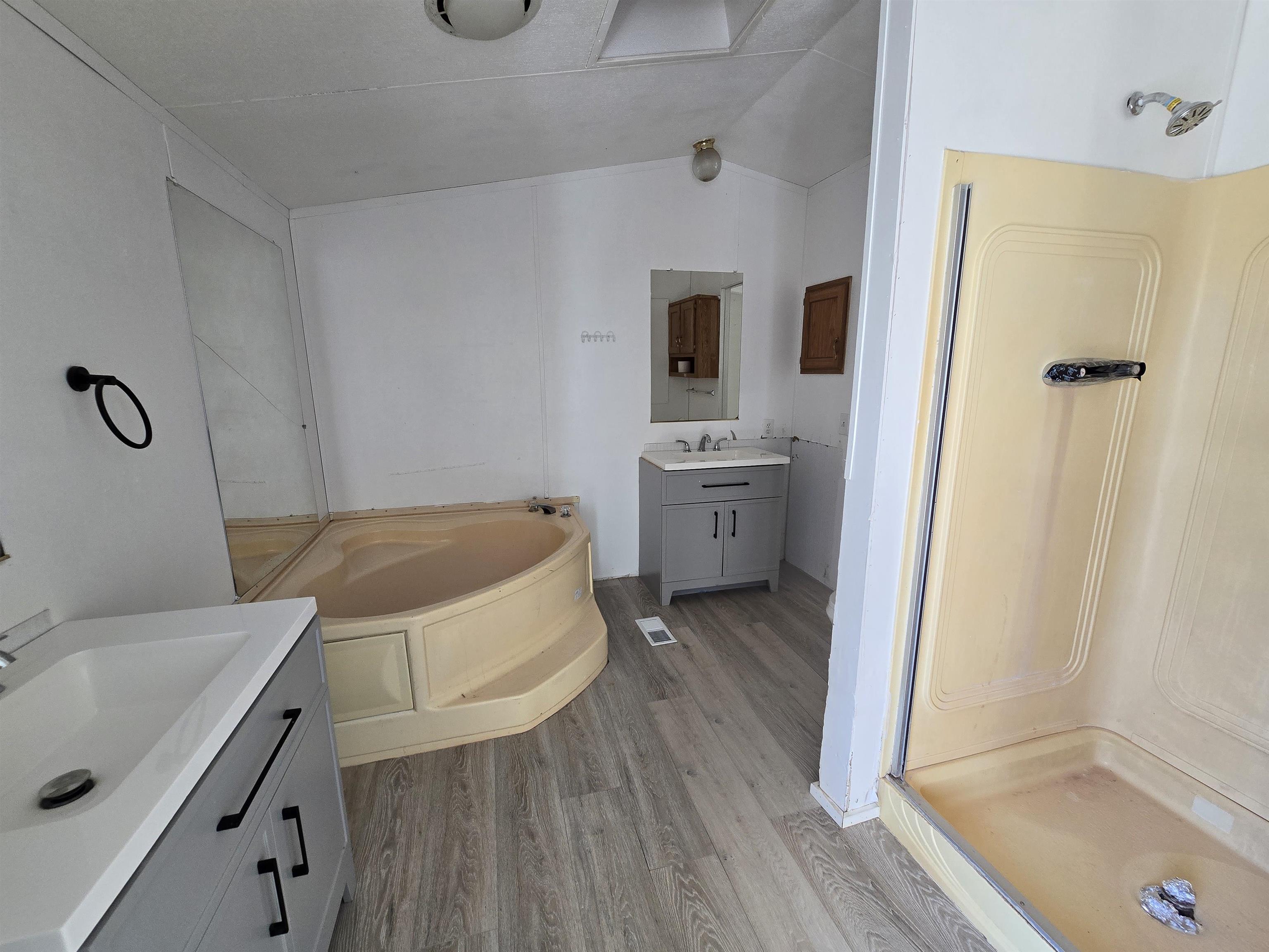 675 1/2 24 1/2 Road Grand Junction, CO 81505 - Photo 18 of 25 a spacious bathroom with a granite countertop sink a mirror and shower