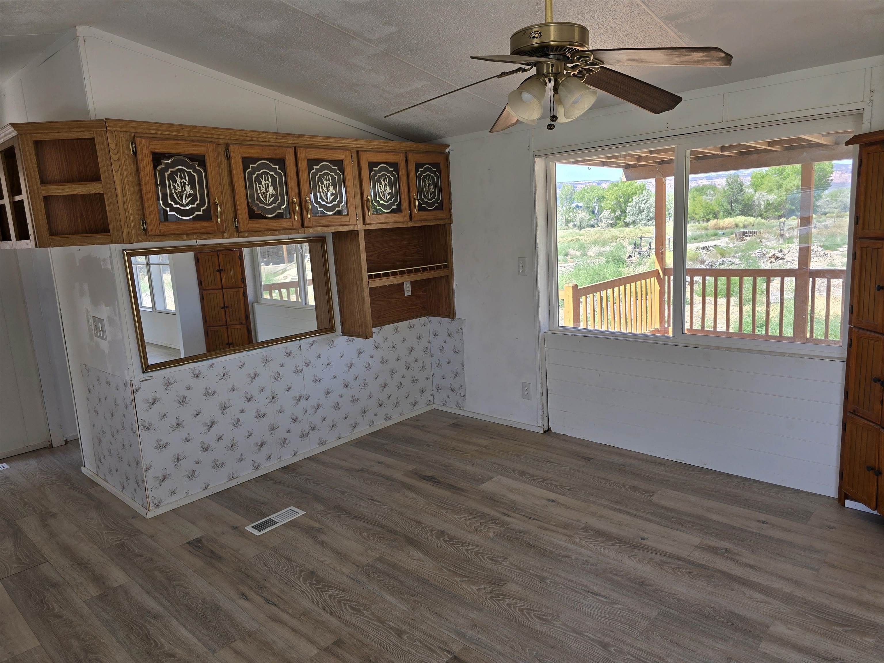 675 1/2 24 1/2 Road Grand Junction, CO 81505 - Photo 2 of 25 a view of an empty room with window and wooden floor
