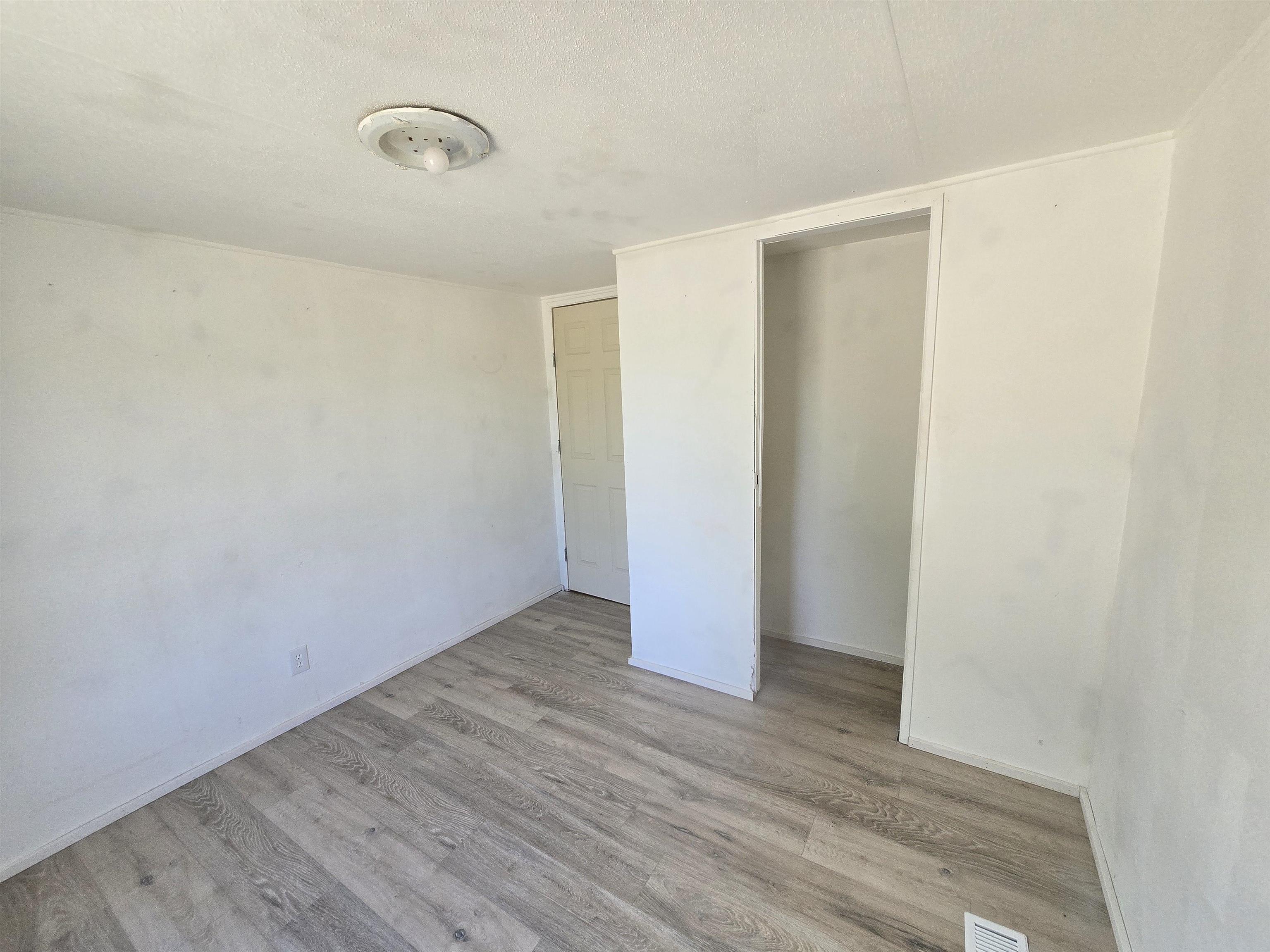675 1/2 24 1/2 Road Grand Junction, CO 81505 - Photo 9 of 25 a view of an empty room with wooden floor