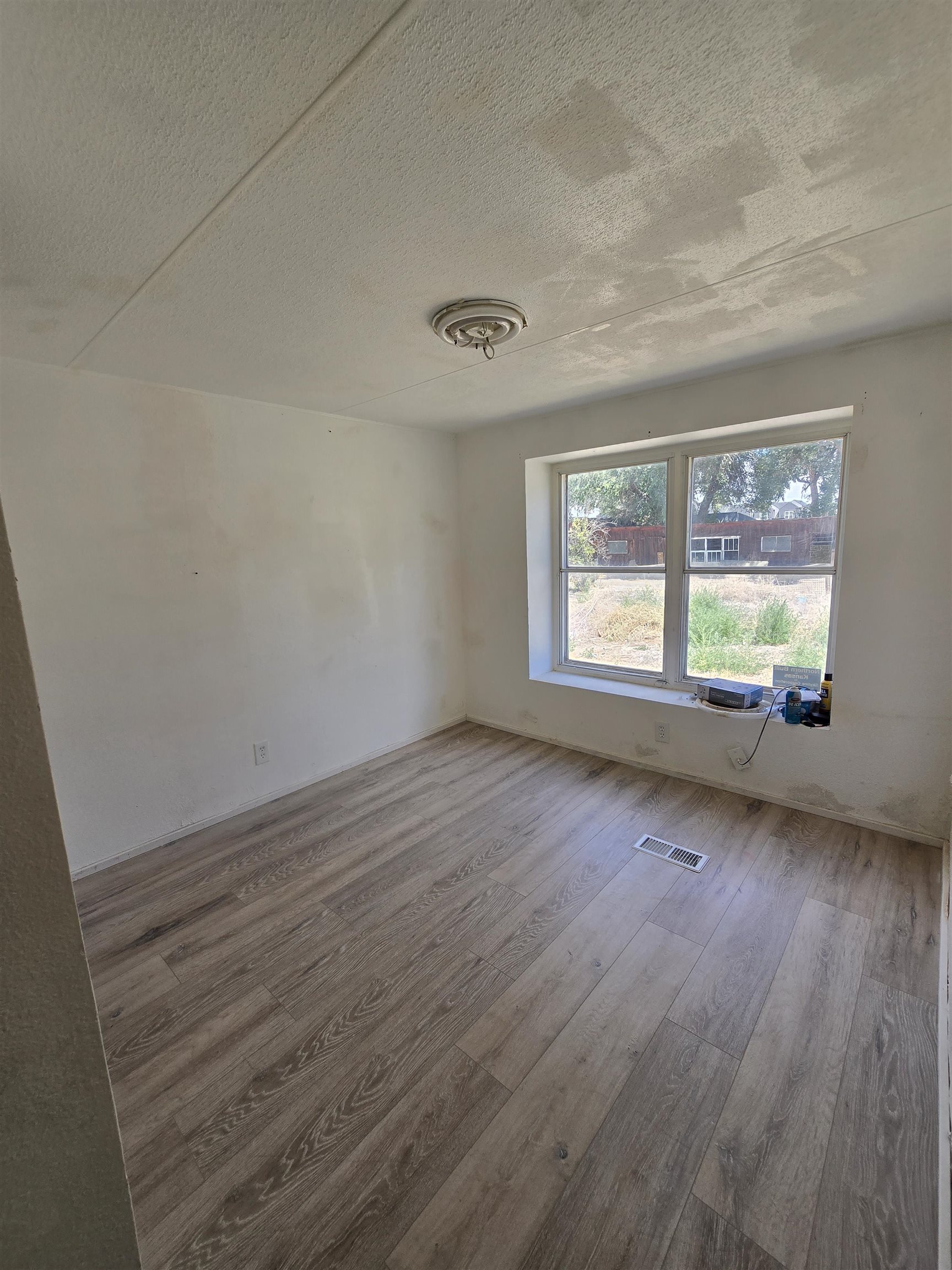 675 1/2 24 1/2 Road Grand Junction, CO 81505 - Photo 10 of 25 an empty room with wooden floor and windows