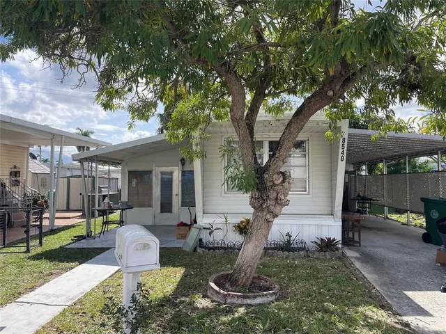 a view of a house with backyard porch and sitting area
