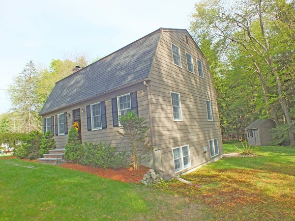 7 Conestoga Road Chelmsford, MA 01824 - Photo 27 of 29 a front view of a house with a garden