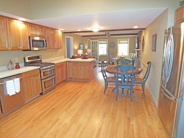 7 Conestoga Road Chelmsford, MA 01824 - Photo 4 of 29 a kitchen with stainless steel appliances granite countertop a kitchen island hardwood floor sink stove dining table and chairs