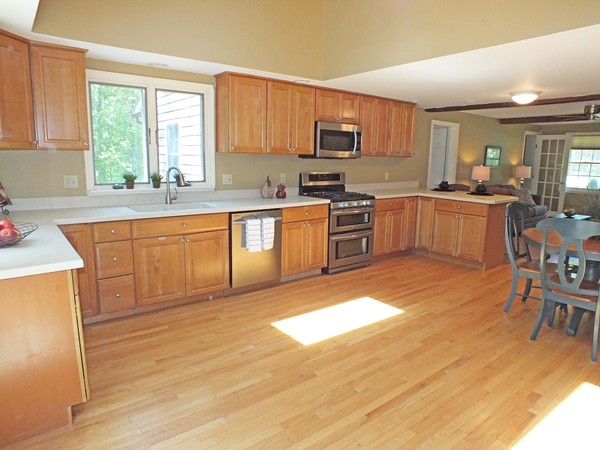 7 Conestoga Road Chelmsford, MA 01824 - Photo 7 of 29 a large kitchen with cabinets wooden floor a center island and stainless steel appliances