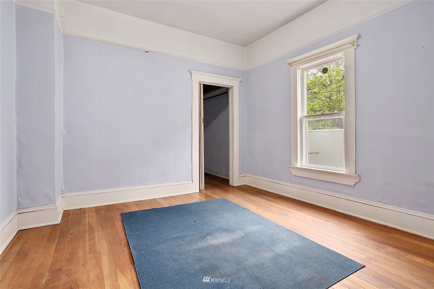 1014 East Maple Street Bellingham, WA 98225 - Photo 19 of 22 an empty room with wooden floor and windows