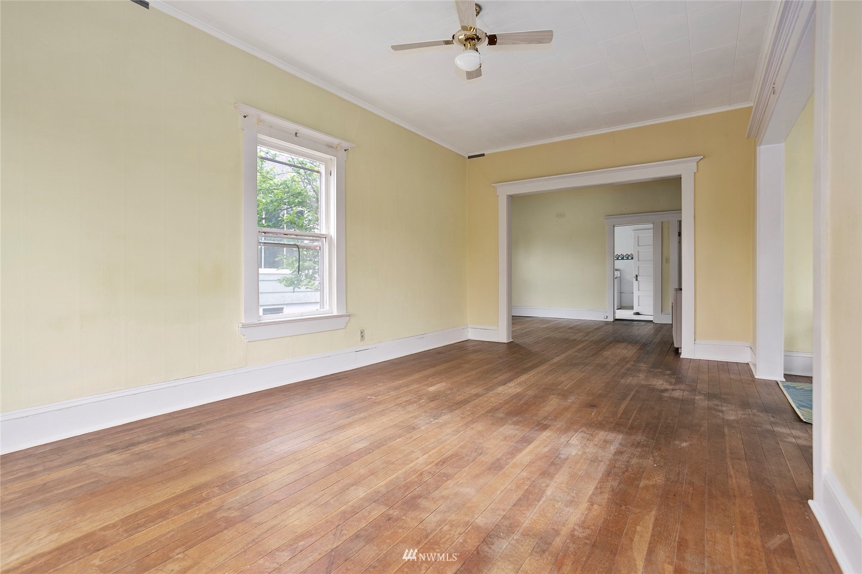 1014 East Maple Street Bellingham, WA 98225 - Photo 6 of 22 a view of empty room with wooden floor and fan
