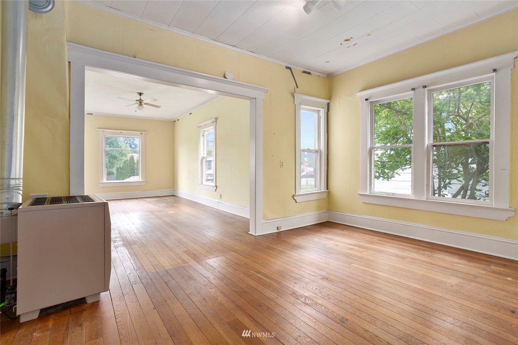 1014 East Maple Street Bellingham, WA 98225 - Photo 7 of 22 a view of an empty room with wooden floor and a window