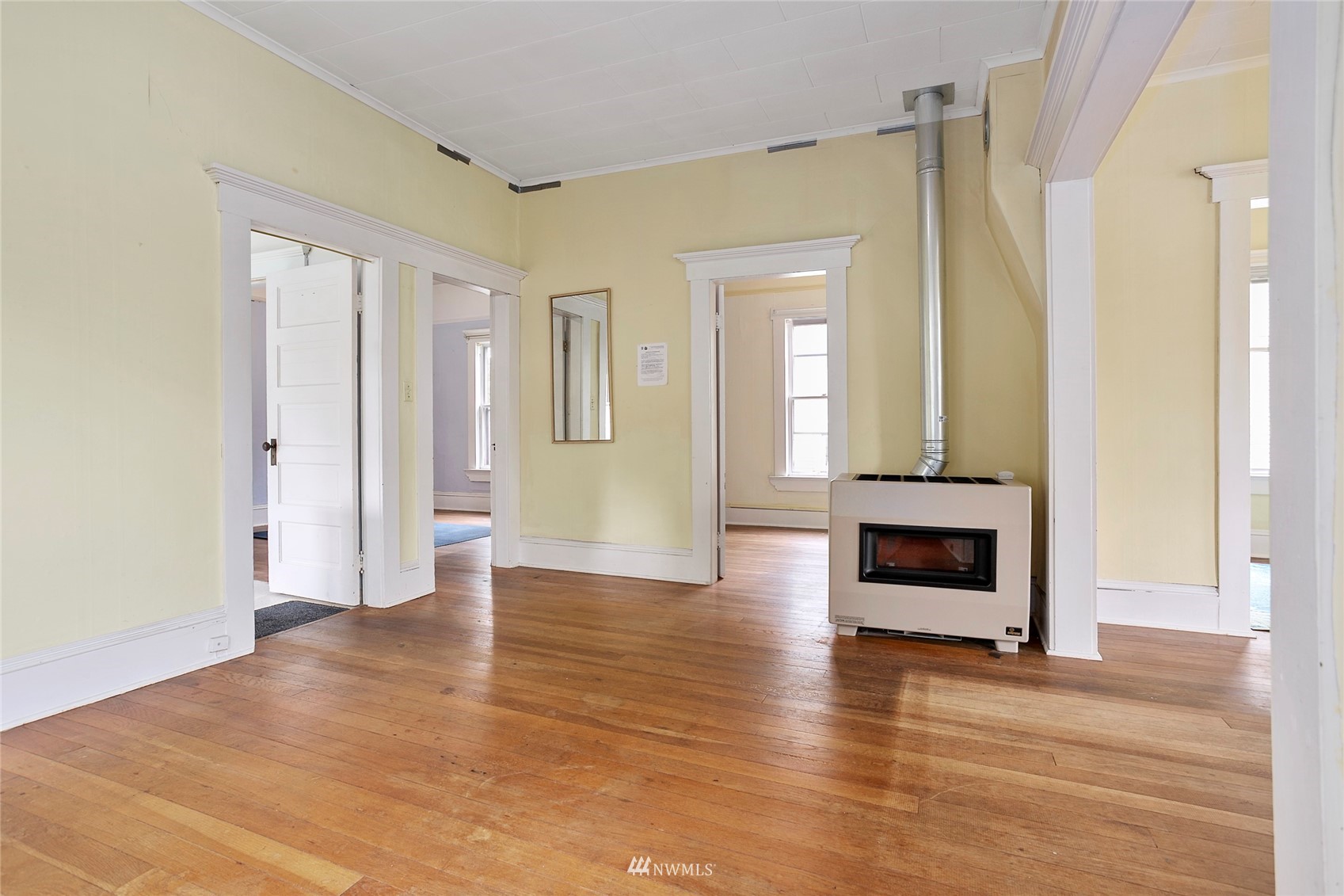 1014 East Maple Street Bellingham, WA 98225 - Photo 9 of 22 a view of an empty room with wooden floor and a window