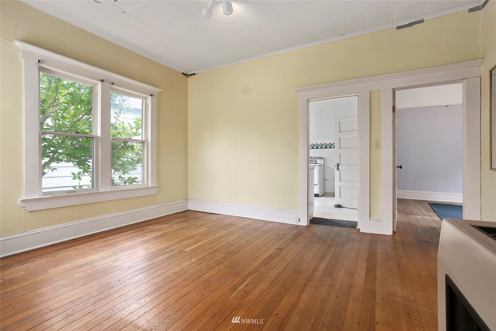 1014 East Maple Street Bellingham, WA 98225 - Photo 10 of 22 an empty room with wooden floor and windows