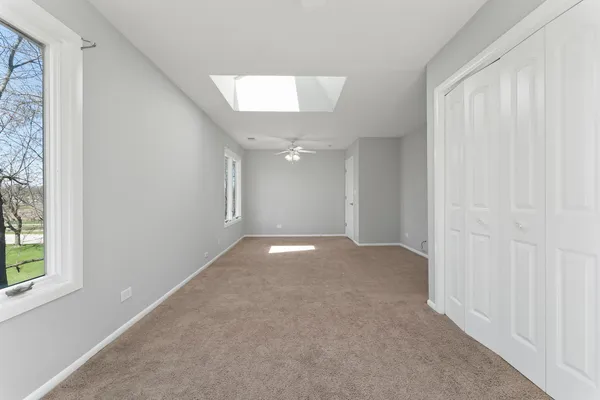 an empty room with windows and entrance