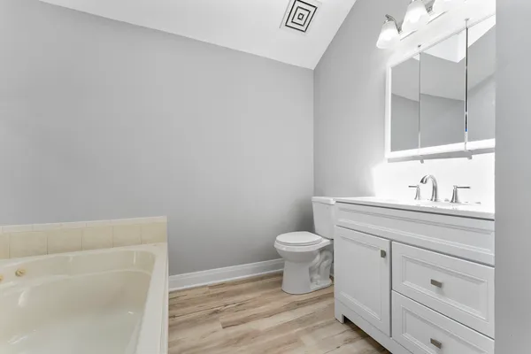 a bathroom with a sink a toilet and vanity