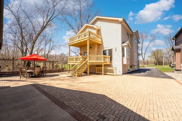 a view of a house with a yard and sitting area