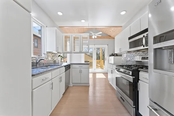a kitchen with stainless steel appliances granite countertop a stove and a refrigerator