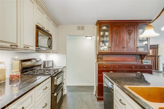 an empty room with windows and chandelier fan