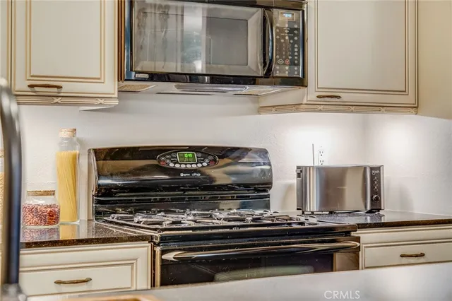 a bathroom with a sink a toilet a mirror and shower