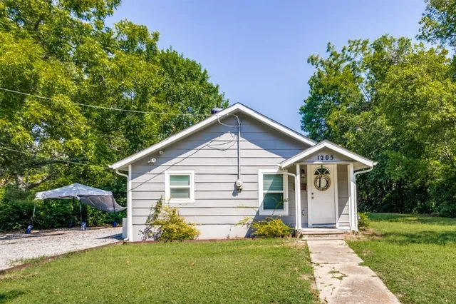 a view of a house with yard and a garden