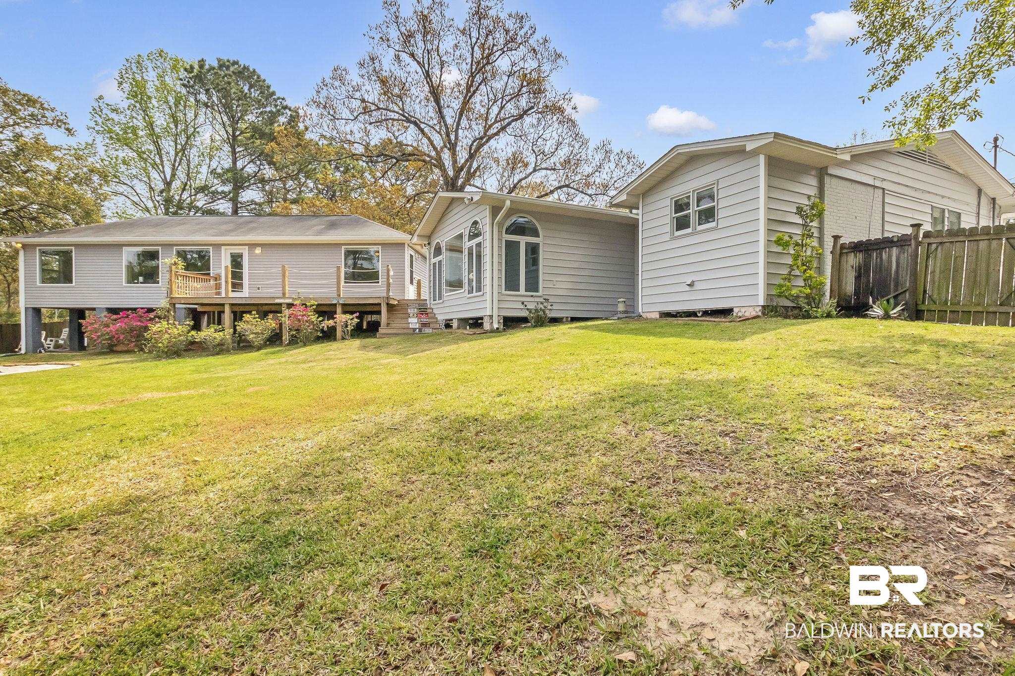 2901 Alston Court Mobile, AL 36605 - Photo 43 of 59 Rear view of house featuring a deck, fence, and a yard