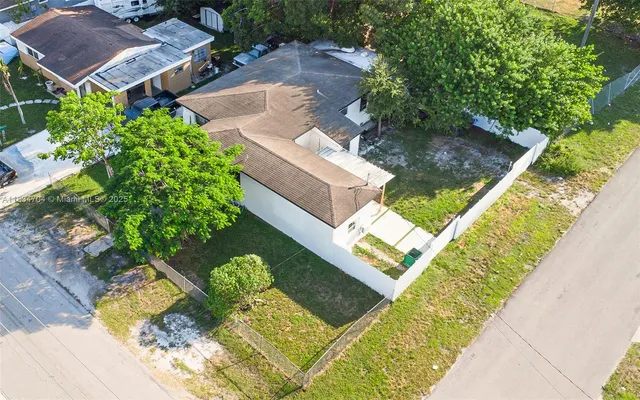 an aerial view of a house with a garden and swimming pool