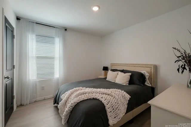 a bedroom with a bed and a window