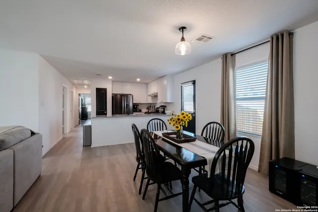a dining room with furniture and window