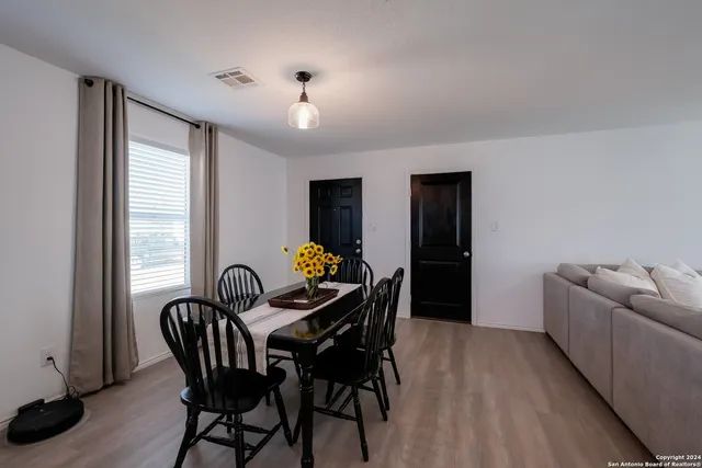 a dining room with furniture and window