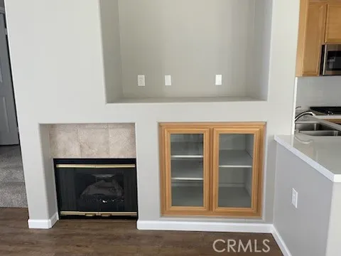 a view of empty room with a fireplace and a window