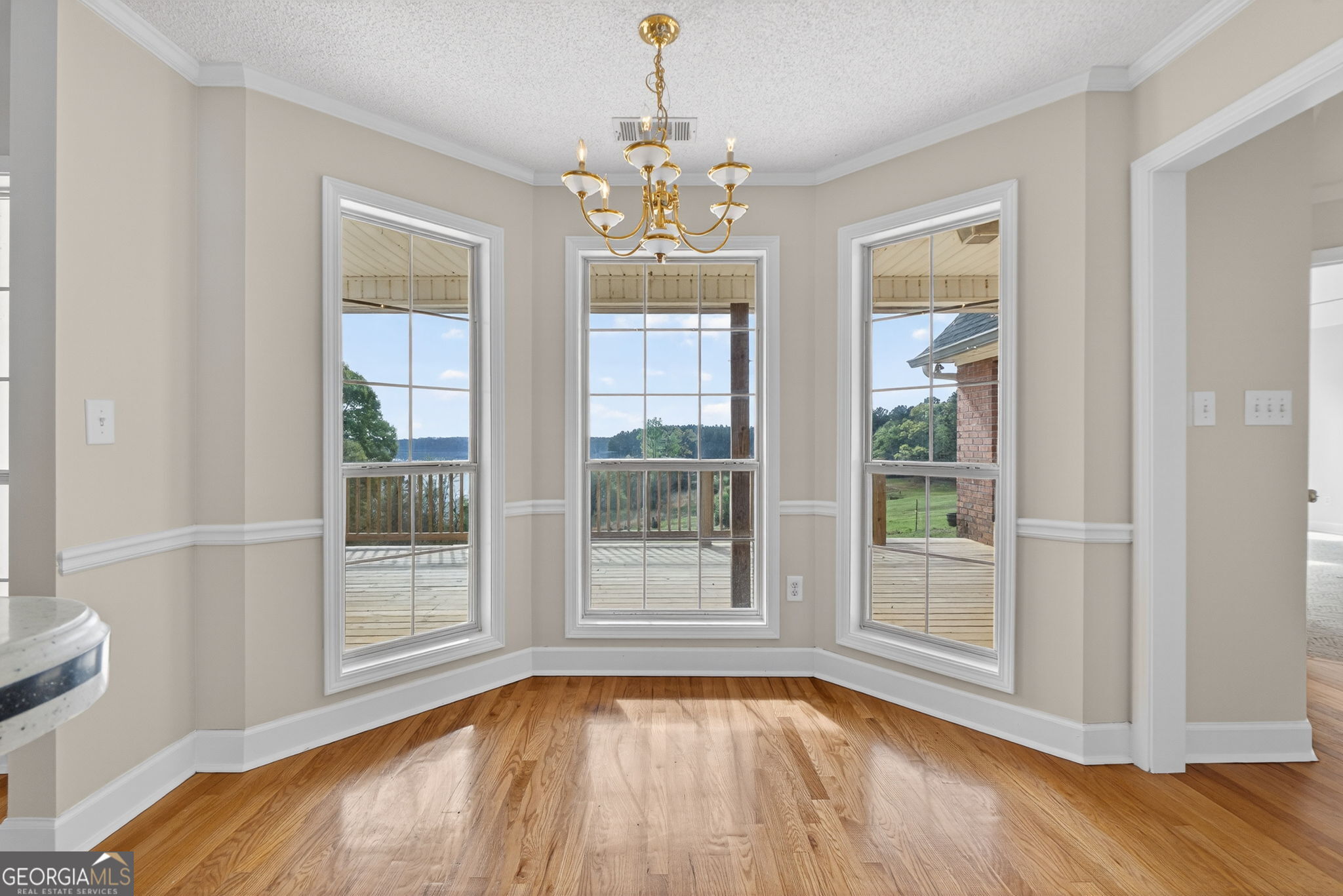 955 Mocassin Gap Road Locust Grove, GA 30248 - Photo 17 of 59 a view of an empty room with wooden floor and a window